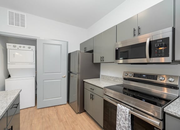 a kitchen with stainless steel appliances and granite counter tops