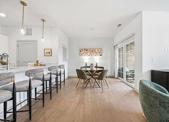 A dining area with a table set for four.