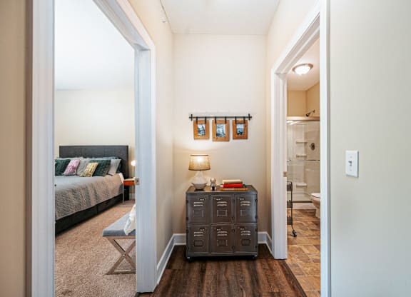a living room with luggage on the floor and a staircase