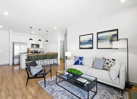 A living room with a white couch and a coffee table.