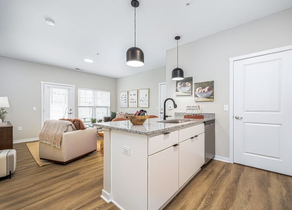 a kitchen with an island and a living room with a couch
