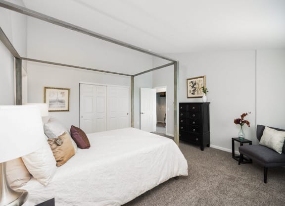 a bedroom with a large bed and a large mirror