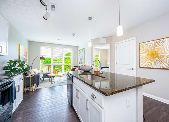 a kitchen with an island and a living room