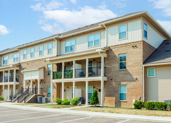 a brick apartment building with balconies and stairs