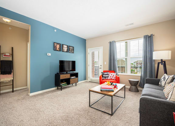 a living room with a blue wall and a couch and a table