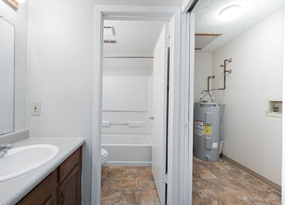 a bathroom with a sink and a shower and a toilet