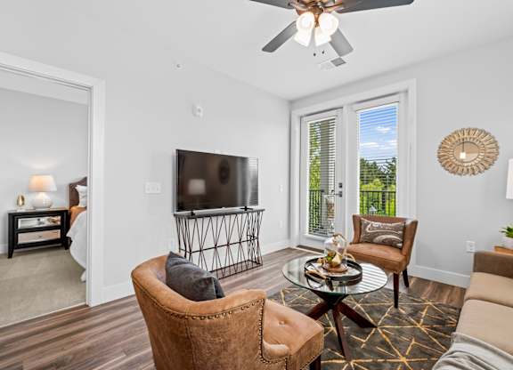 A living room with a brown leather chair and a glass coffee table.