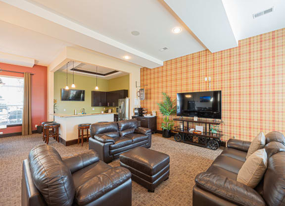 a living room with leather furniture and a television