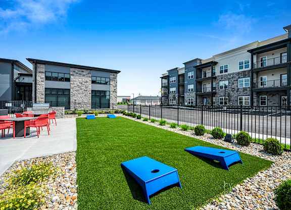 A modern outdoor seating area with blue benches and tables.