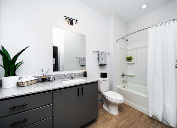 A bathroom with a white toilet and a white sink.