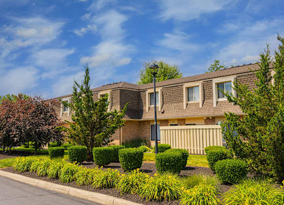 A row of houses with a street in front.