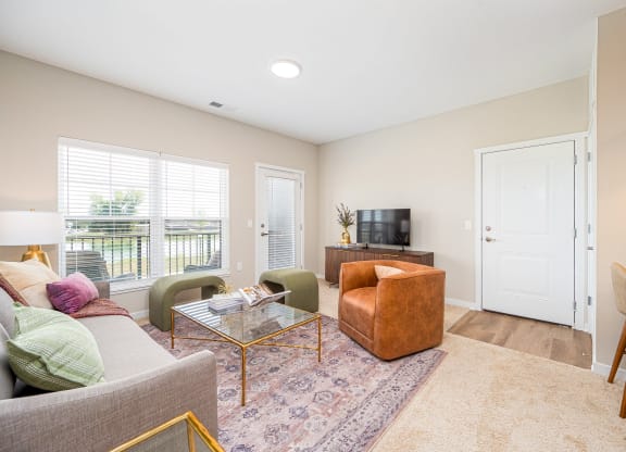 a living room with a couch and a chair and a television