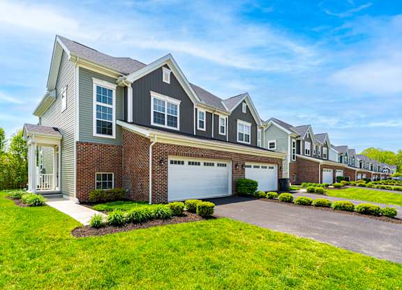 A row of houses with a clear blue sky above them.