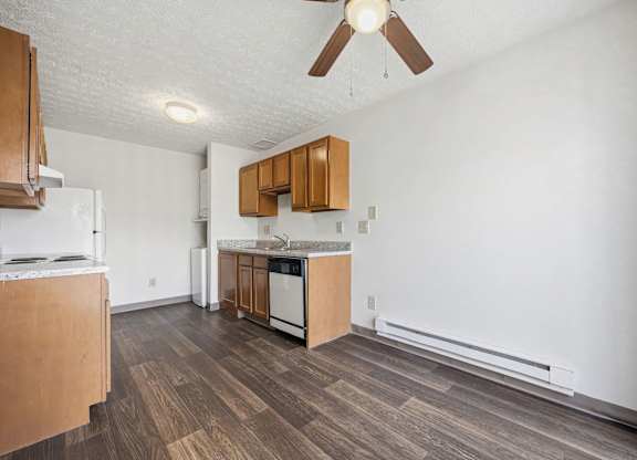 A kitchen with wooden floors and white walls.