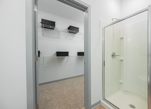 a bathroom with a shower and a glass door