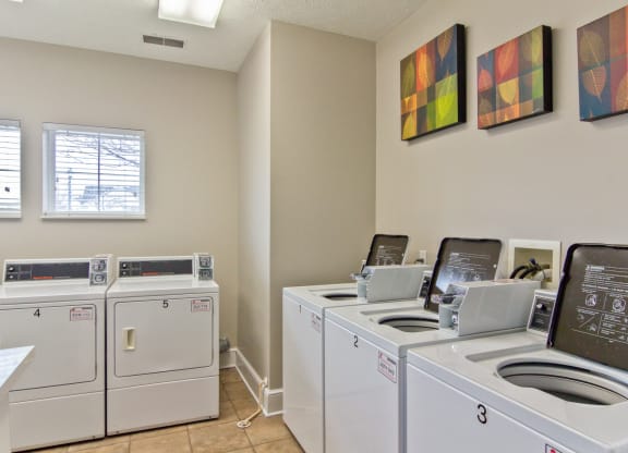 washers and dryers in the laundry room of an apartment building