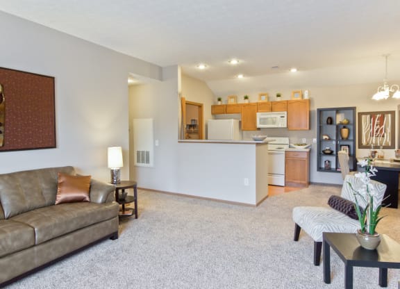 a living room and kitchen with a couch and a table