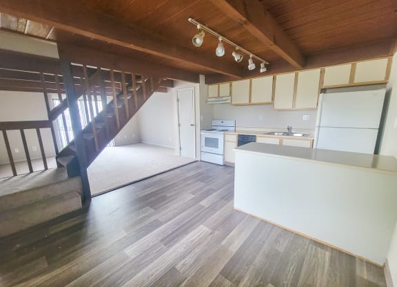 an open floor plan with a staircase leading up to the second floor