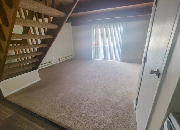 a view from the bottom of the stairs looking into the living room