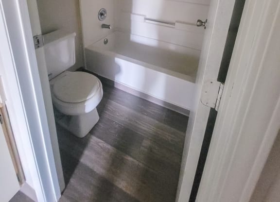 a small bathroom with a toilet and a bathtub