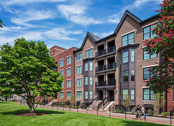 a large apartment building with a tree in front of it