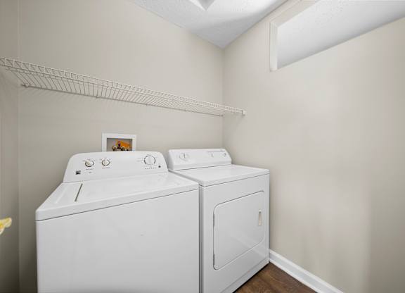 A white washing machine and dryer in a laundry room.