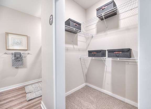 A room with a white wall and a picture frame on it.