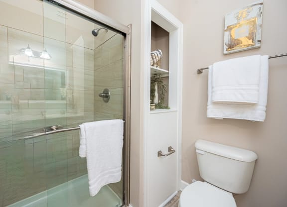 a bathroom with a toilet and a glass shower