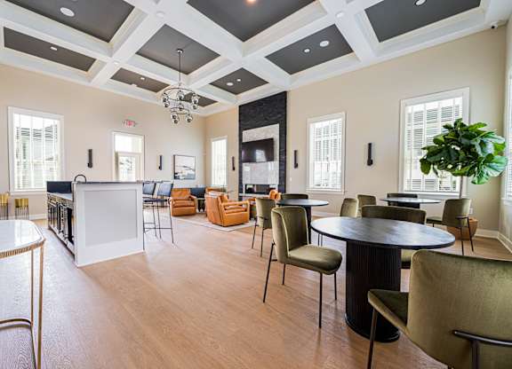 A large room with a white table and chairs.