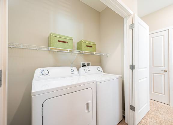 A white washer and dryer in a laundry room.