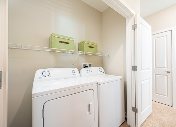 a washer and dryer in a laundry room with a closet