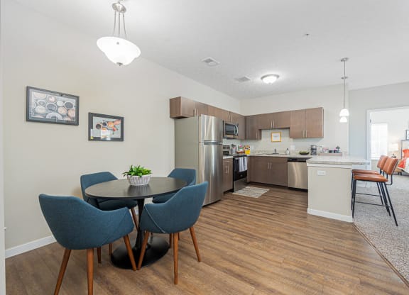 an open kitchen and dining area with a table and chairs