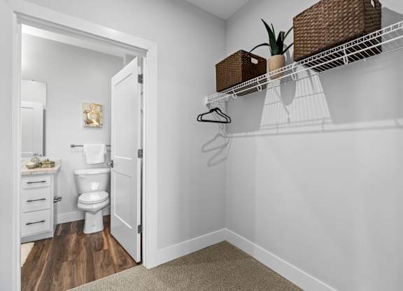 A white bathroom with a toilet, sink, and a white door.