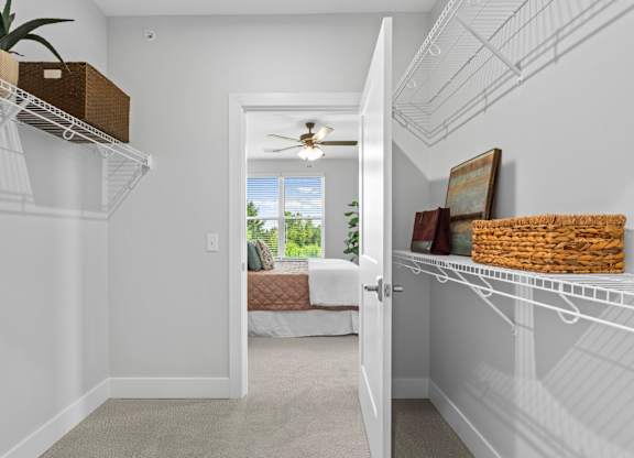 A white room with a white door leading to a balcony.
