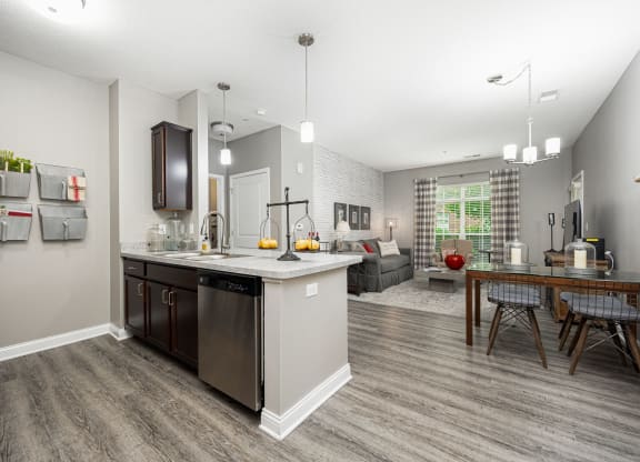 an open kitchen and living room with a table and chairs