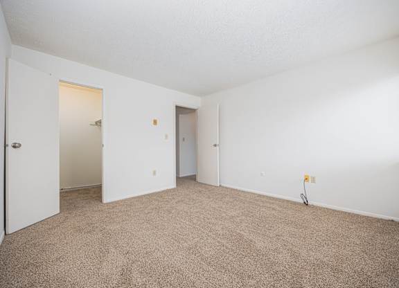 A room with carpeted floor and white walls.