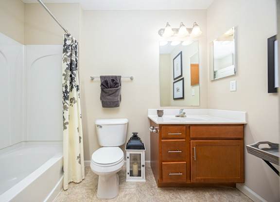 A bathroom with a white toilet, a white sink, and a white bathtub.