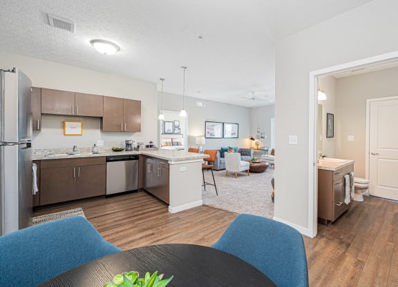 a kitchen and living room with a table and chairs