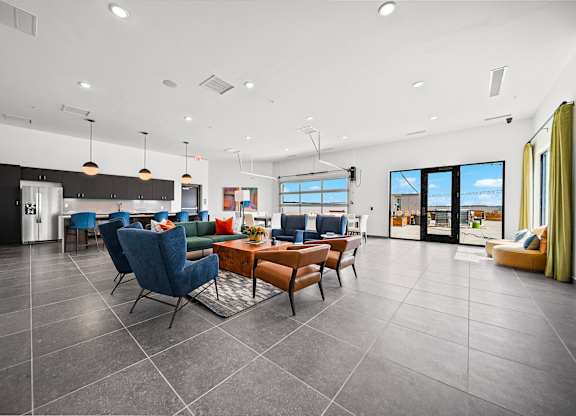 A modern living room with a kitchen in the background.