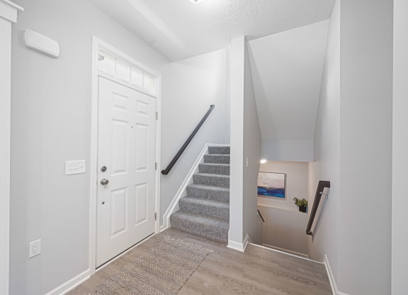 the entryway of liberty reserve with stairs and a white door