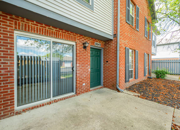 the entrance to a brick building with a green door