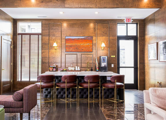 a bar with chairs and a marble table in a lobby