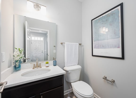 a bathroom with a toilet and a sink and a mirror