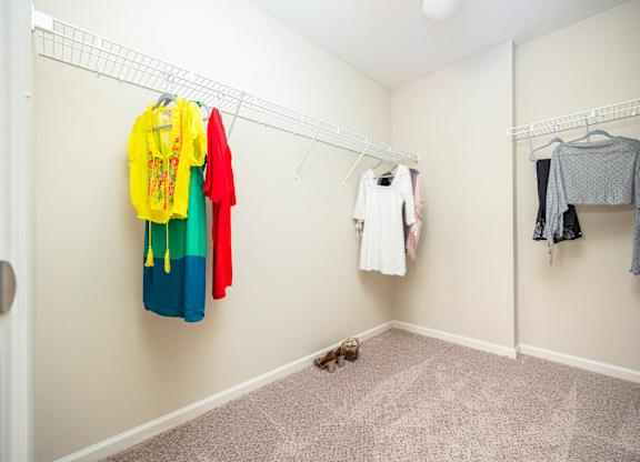 A hallway with clothes hanging on the wall.