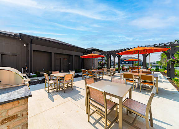 A patio with tables and chairs is set up outside a building.
