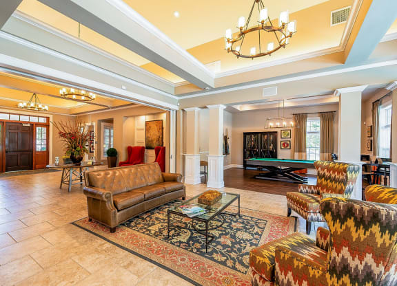 a living room with couches and a pool table