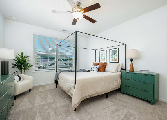 a bedroom with a bed and a ceiling fan