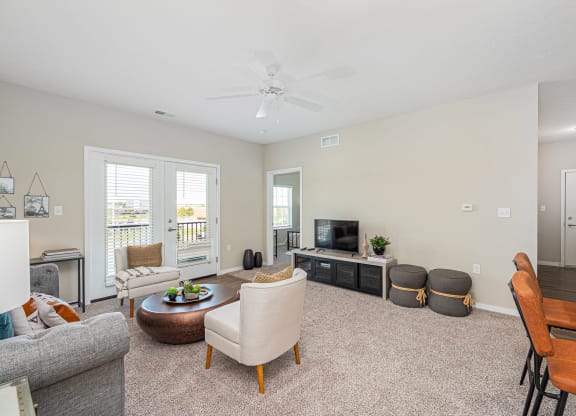 a living room with furniture and a ceiling fan