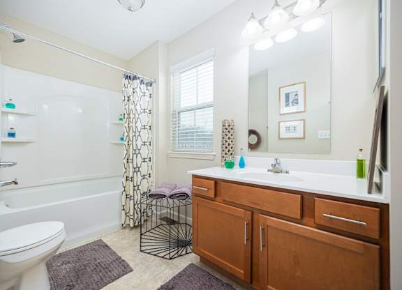 A bathroom with a white toilet, a white sink, and a white bathtub.