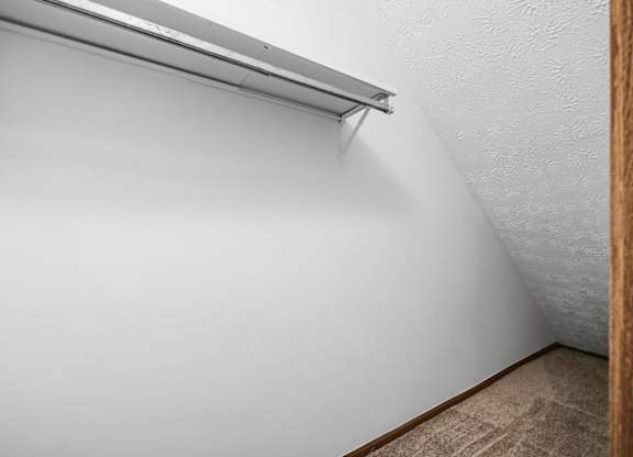A white wall with a wooden frame and a white ceiling.